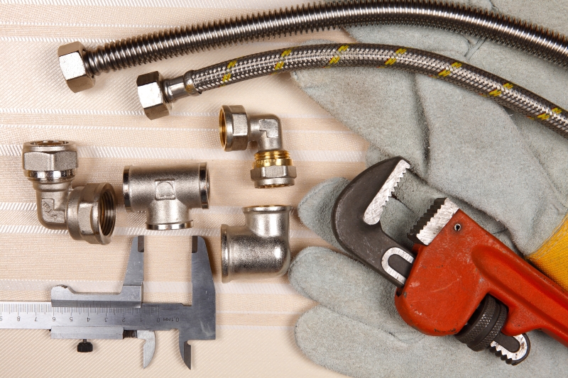 Plumber working on pipes in a Dagenham home